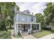 Charming two-story blue home featuring a spacious covered front porch with elegant white columns at 250 N Home Ave, Franklin, IN 46131