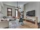 Bright living room features a decorative fireplace, ceiling fan, and hardwood floors at 250 N Home Ave, Franklin, IN 46131