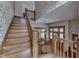 Traditional staircase showcasing wood trim and decorative wallpaper, creating a warm and inviting entryway at 250 N Home Ave, Franklin, IN 46131