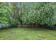 Spacious backyard featuring a wood fence and mature trees providing ample shade and privacy at 2720 S Taft Ave, Indianapolis, IN 46241