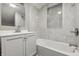 Bright bathroom featuring a tub with tile surround and a vanity with sleek fixtures at 2720 S Taft Ave, Indianapolis, IN 46241