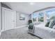 Bedroom with ample sunlight, green accents, and neutral walls and carpet at 2720 S Taft Ave, Indianapolis, IN 46241