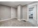 Neutral bedroom with gray carpet, gray walls and view into a secondary bedroom at 2720 S Taft Ave, Indianapolis, IN 46241