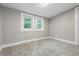 Empty bedroom with neutral carpet, gray walls, and two windows for natural light at 2720 S Taft Ave, Indianapolis, IN 46241