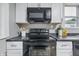 Close up of kitchen appliances including microwave and oven at 2720 S Taft Ave, Indianapolis, IN 46241
