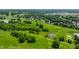 Expansive aerial view of the golf course and surrounding community, showcasing its lush greenery and serene lakes at 289 Sandbrook Dr, Noblesville, IN 46062