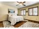 Bright bedroom with hardwood floors, a ceiling fan, and windows dressed with wood blinds at 289 Sandbrook Dr, Noblesville, IN 46062