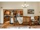 Cozy dining room featuring a rustic wooden table and a view into the modern kitchen at 289 Sandbrook Dr, Noblesville, IN 46062
