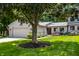 Charming home exterior with stone accents, a well-manicured lawn and an attached two-car garage at 289 Sandbrook Dr, Noblesville, IN 46062