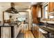 Open kitchen with granite countertops, stainless appliances, and hardwood floors at 289 Sandbrook Dr, Noblesville, IN 46062