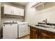 Well-lit laundry room features modern washer and dryer, and sink at 289 Sandbrook Dr, Noblesville, IN 46062