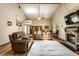 Inviting living room featuring a fireplace, hardwood floors, and comfortable leather seating at 289 Sandbrook Dr, Noblesville, IN 46062