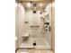 Modern shower featuring elegant marble tiling, a sleek glass enclosure, and matte black fixtures at 289 Sandbrook Dr, Noblesville, IN 46062