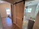 Bathroom entrance with sliding barn door leading to bedroom, unique vessel sink with rock details at 302 Penn St, Westfield, IN 46074