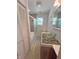Bathroom featuring vessel sink, rock detail, tub/shower, linen closet, and modern fixtures at 302 Penn St, Westfield, IN 46074