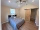 Bedroom with wood floors, vaulted ceiling, modern decor, and sliding barn door access at 302 Penn St, Westfield, IN 46074