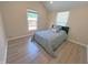 Bright bedroom with wood floors, neutral walls, and large window overlooking backyard at 302 Penn St, Westfield, IN 46074
