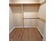 Walk-in closet with wood floors and custom shelving and rod system at 302 Penn St, Westfield, IN 46074