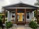 Charming home featuring a covered front porch with seating and a bright yellow door at 302 Penn St, Westfield, IN 46074