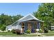 Charming exterior view featuring a welcoming front porch, colorful landscaping, and inviting curb appeal at 302 Penn St, Westfield, IN 46074