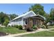 Inviting home exterior displaying manicured lawn, colorful flowerbeds, and a covered front porch at 302 Penn St, Westfield, IN 46074