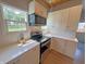 Modern kitchen with stainless steel appliances, quartz countertops, white subway tile backsplash, and wood floors at 302 Penn St, Westfield, IN 46074