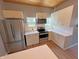 White kitchen with stainless steel appliances, white subway tile backsplash, wood floors, and wooden ceiling at 302 Penn St, Westfield, IN 46074