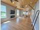 Open living space featuring wood floors, a modern fireplace, and views into the kitchen at 302 Penn St, Westfield, IN 46074