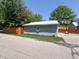 Garage style outbuilding with metal roof, window flower box, and basketball hoop at 302 Penn St, Westfield, IN 46074