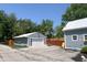 Two garage style outbuildings with metal roofs and a basketball hoop on the concrete pad at 302 Penn St, Westfield, IN 46074