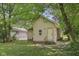 Exterior view displaying the home's backyard, with a green lawn and mature shade trees surrounding the property at 3028 Hovey St, Indianapolis, IN 46218