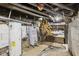 Unfinished basement area with a water heater and wooden stairs at 3028 Hovey St, Indianapolis, IN 46218