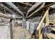 Unfinished basement with exposed pipes and water heater at 3028 Hovey St, Indianapolis, IN 46218
