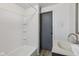 Bright bathroom featuring clean white tiles, a shower/tub combo, and modern fixtures at 3028 Hovey St, Indianapolis, IN 46218