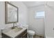 Bathroom with a modern vanity, toilet, framed mirror and shower and a window for natural light at 3028 Hovey St, Indianapolis, IN 46218