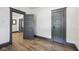 An empty bedroom featuring gray trim, doors, and light wood-look flooring at 3028 Hovey St, Indianapolis, IN 46218