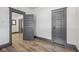 Bedroom featuring plank flooring, classic trim, and access to other rooms at 3028 Hovey St, Indianapolis, IN 46218