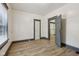 Empty bedroom with light wood-look floors and access to other rooms at 3028 Hovey St, Indianapolis, IN 46218
