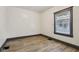 A minimalist bedroom with light wood-look flooring and natural light at 3028 Hovey St, Indianapolis, IN 46218