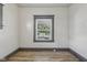 Bright bedroom featuring plank flooring and a window with pleasant outdoor views at 3028 Hovey St, Indianapolis, IN 46218