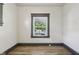 A bright bedroom with a window and gray trim, creating a serene atmosphere at 3028 Hovey St, Indianapolis, IN 46218