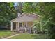 Charming home with a brick chimney and front yard with a brick walkway to the front porch at 3028 Hovey St, Indianapolis, IN 46218