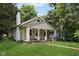 Inviting single-Gathering home with a covered porch, classic design, and a well-manicured front yard at 3028 Hovey St, Indianapolis, IN 46218