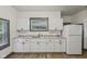 Bright kitchen featuring white cabinets, ample counter space, and modern appliances at 3028 Hovey St, Indianapolis, IN 46218