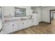 Well-lit kitchen with white cabinetry, a large window, and modern appliances at 3028 Hovey St, Indianapolis, IN 46218