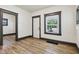 Bright living room features new laminate flooring, fresh paint, and a view to the outside at 3028 Hovey St, Indianapolis, IN 46218