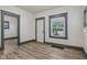 Spacious living room with new laminate flooring, white walls and neutral gray trim at 3028 Hovey St, Indianapolis, IN 46218