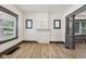Open-concept living room features a decorative fireplace, new flooring, and stylish gray trim at 3028 Hovey St, Indianapolis, IN 46218