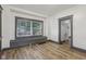 Living room with a cozy built-in bench under a bright window and stylish flooring at 3028 Hovey St, Indianapolis, IN 46218