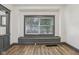 Bright living room with a cozy built-in bench under a window, and plank flooring at 3028 Hovey St, Indianapolis, IN 46218